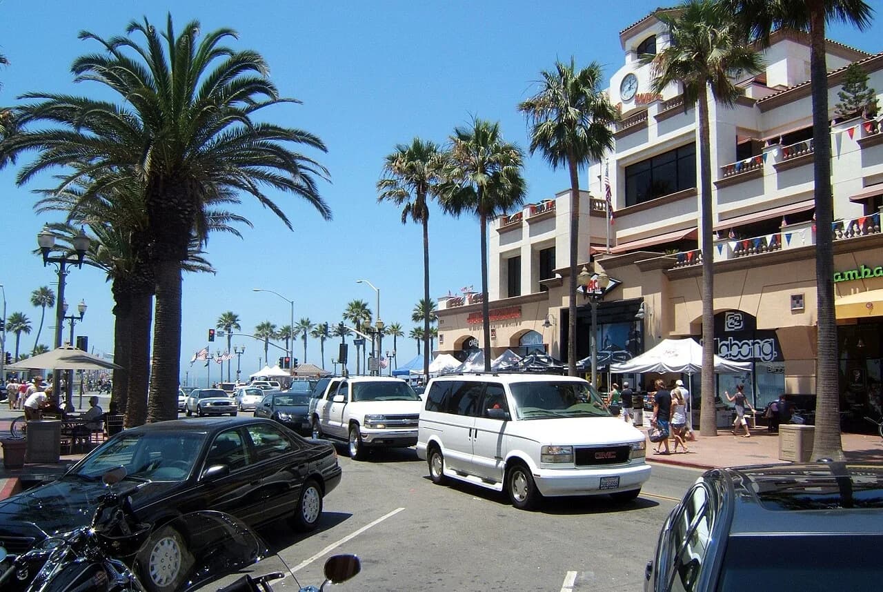 Palm-lined street leading toward the Huntington Beach pier